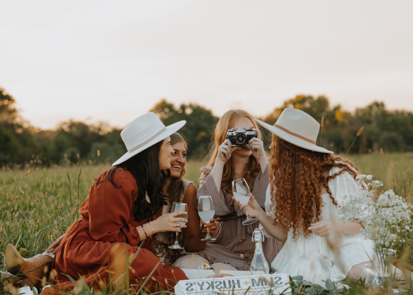 group of friends having a picnic in a field